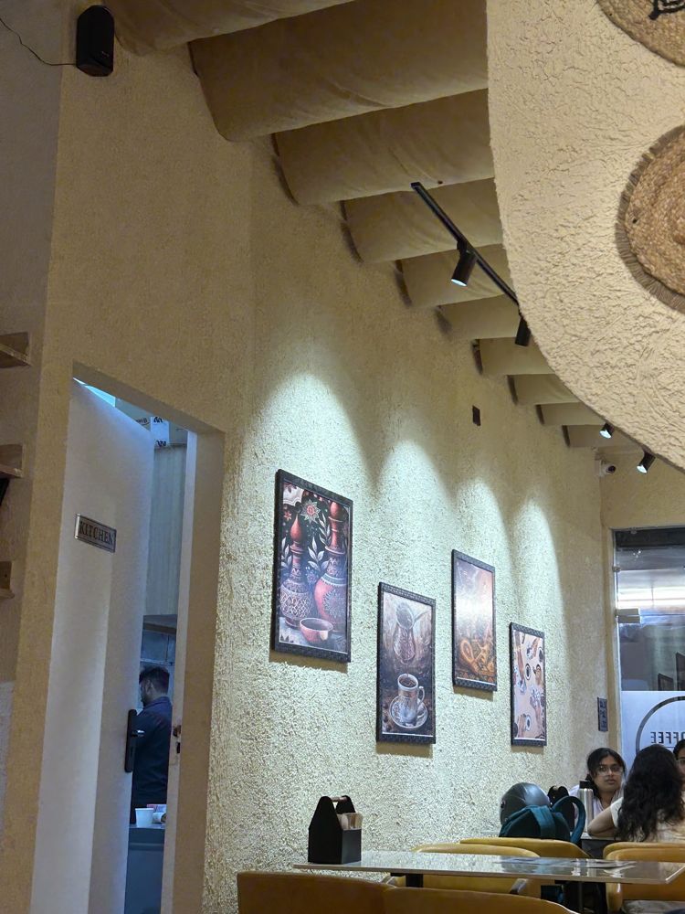 Framed coffee prints on the plaster wall